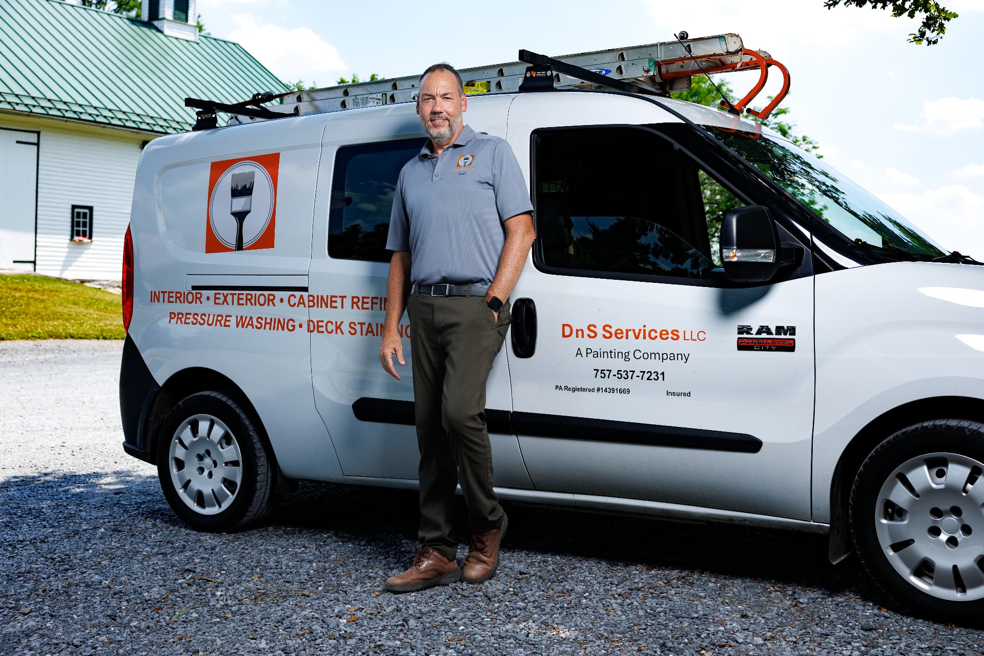 Sean Brown standing beside the DnS Services LLC work van