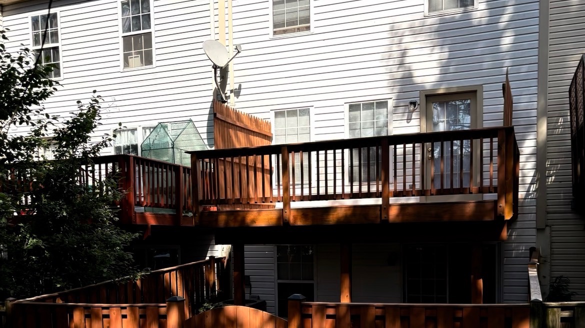 Stained elevated deck and privacy railing on a townhouse